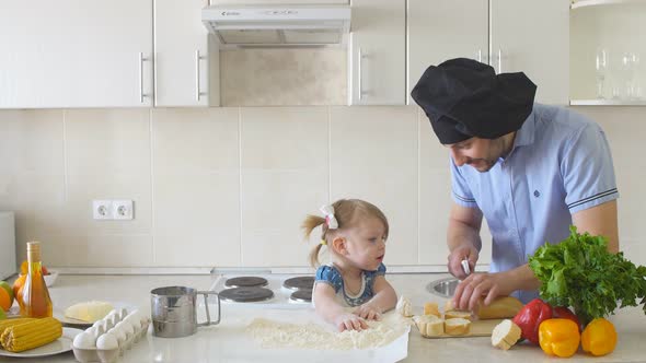 Father and Daughter Cooking at the Kitchen