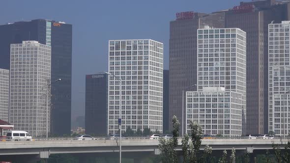 busy traffic and modern buildings in Beijing city , China.