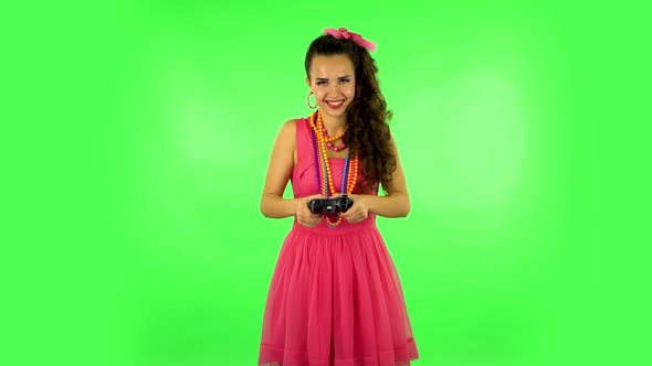 Girl Playing a Video Game Using a Wireless Controller. Green Screen