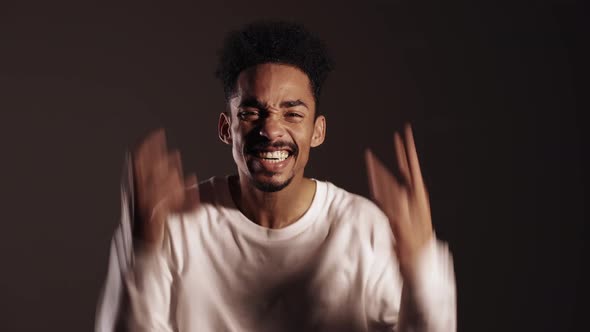 Young African Stressed Man in White Shirt Shouting Isolated Over Dark Background