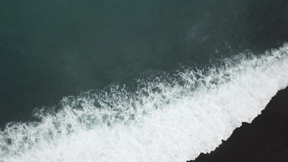 Aerial view the wave hit the sand at beach