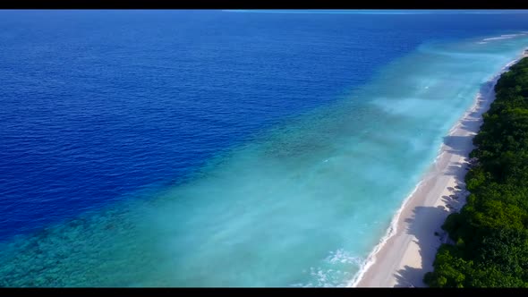 Aerial drone shot seascape of tropical tourist beach trip by blue sea with clean sandy background of