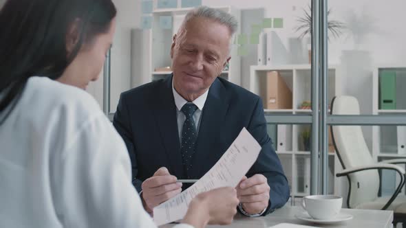 Smiling Old Manager Interviewing Unrecognizable Candidate