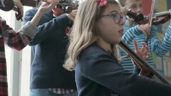 Girl playing cello during lesson