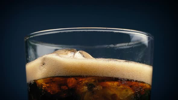 Coke Pours and Froths Over Glass