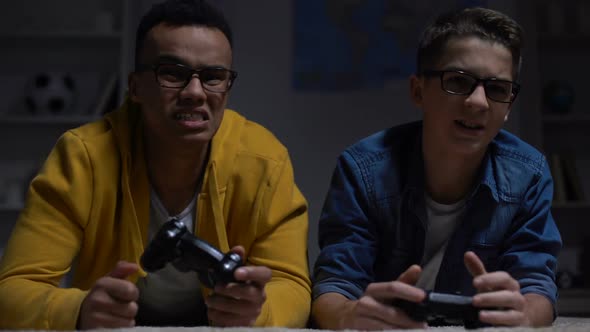 Anxious Multiethnic Friends Losing Video Game, Accusing Each Other, Addiction