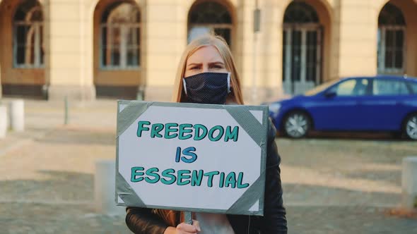 Woman in Mask on Protest Walk Calling That Freedom is Essential