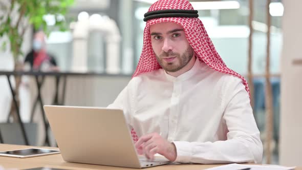 Serious Arab Businessman with Laptop Saying No with Finger Sign