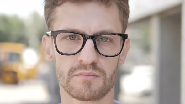 Outdoor Close up of Young Man in Glasses