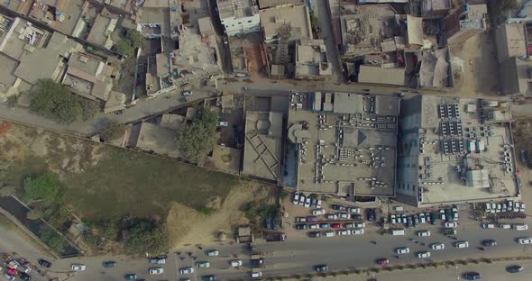 Bombay, India,Quick Aerial slide shot of an old area, showing cars moving on a road, Another big roa