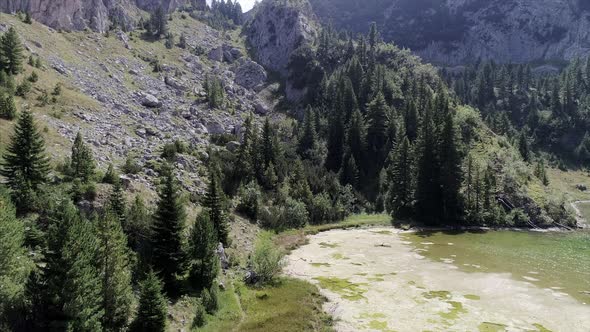 Pedestal shot of Rugova Lake and Rugged Mountains in Kosovo