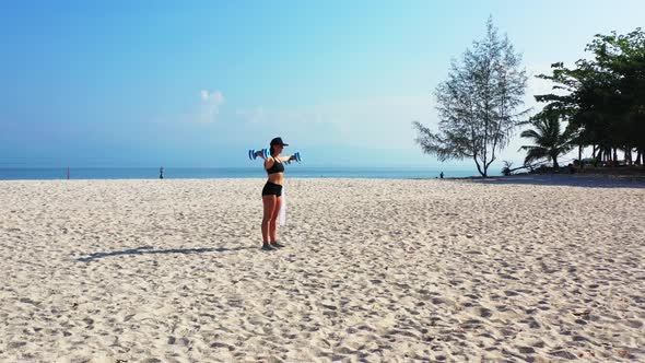 Beautiful Beauty Models Traveling Spending Quality Time at The Beach on Clean White Sand and Blue