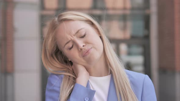 Tired Young Businesswoman with Neck Pain