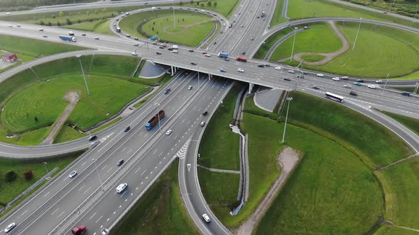 Cars Drive Along Multilevel Traffic Intersection on Meadows