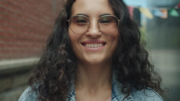 Closeup Portrait of Cute Mixed Race Woman in Glasses Smiling and Laughing Outside in City Street