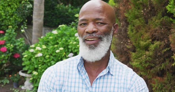 Portrait of smiling senior african american man looking at camera in garden