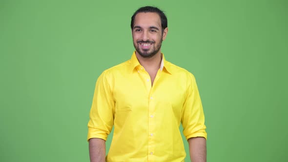 Young Happy Bearded Indian Businessman Smiling While Thinking