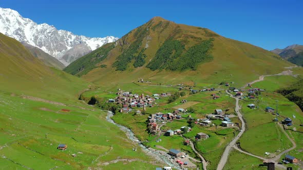 Aerial View of a Mountain Village in the Middle of a Sunny Summer Day