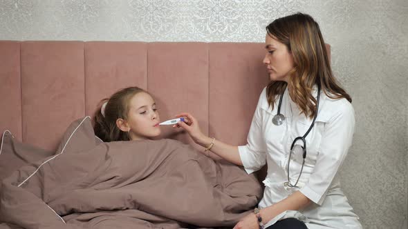 Doctor Measures Temperature of Teen Girl in Bedroom at Home
