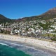 Wide aerial view of Camps Bay beach filled with a ton of beachgoers - VideoHive Item for Sale