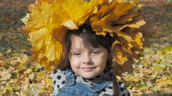 Portrait of a Child in Yellow Leaves