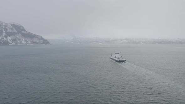 Aerial View Of Ferry Cruising From Olderdalen To Lyngseidet On Foggy Kaafjord, Norway - drone shot