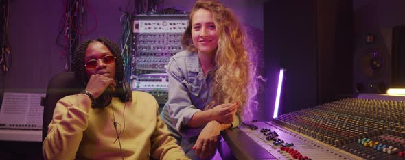 Portrait of Multiethnic Man and Woman in Recording Studio