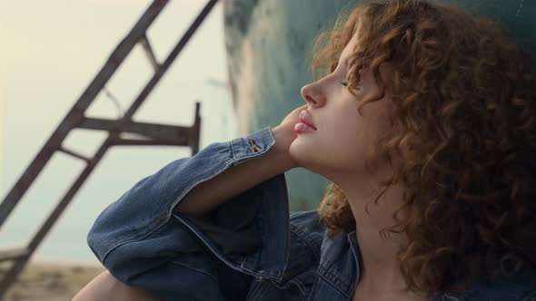 Dreamy Woman Sitting Beach Gloomy Evening Leaning on Old Abandoned Boat Close Up