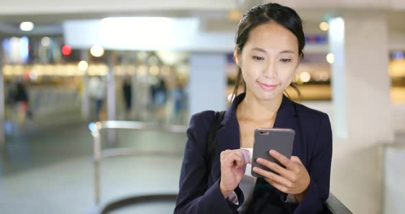 Businesswoman use of cellphone in Hong Kong city 