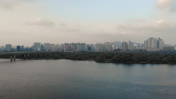 Aerial. 4K video. Dawn. Sun. Building. River Han. Sky. Fog. Panorama. Road. Cars. The camera is Poin