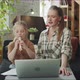 A Young Mother Helps Her Daughter in an Online Music Class - VideoHive Item for Sale