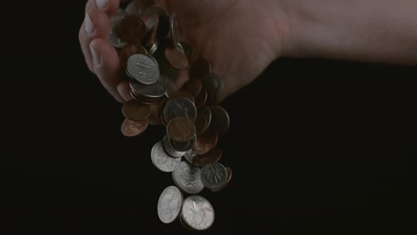 Hand dropping coins in slow motion; shot on Phantom Flex 4K at 1000 fps