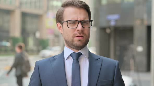 Portrait of Businessman showing No Sign by Head Shake