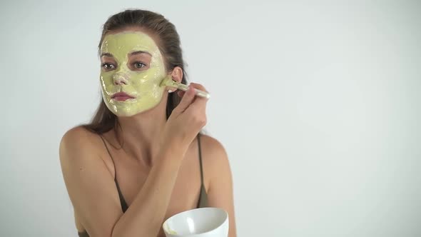 A Young Beautiful Girl Applies a Moisturizing Mask to Her Face