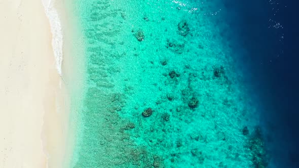 Aerial flying over scenery of luxury island beach vacation by blue lagoon and white sand background 