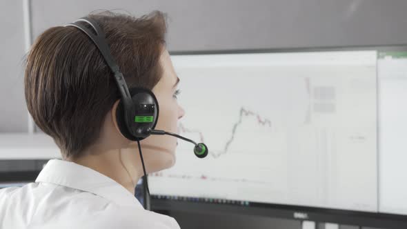 Rear View Shot of a Female Call Center Agent Wearing Headset While Working