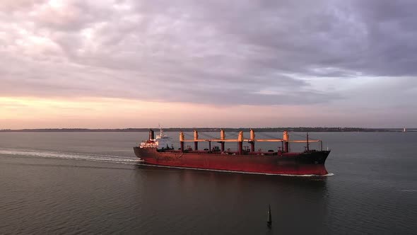 Tracking Aerial of Cargo Bulker on Its Tranportation Voyage During Sunset