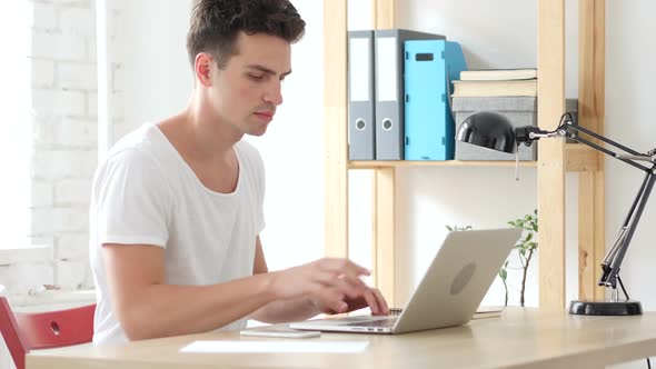 Creative Man Coming to Office, Starts Work on Laptop