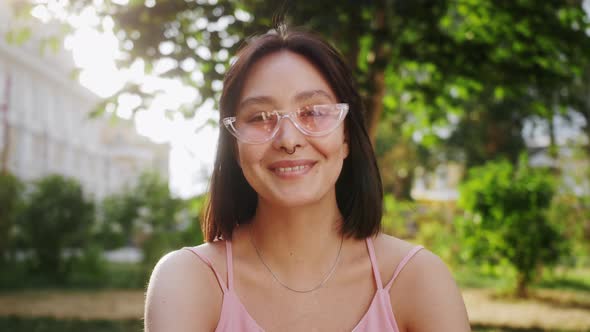 Portrait of pleasant young girl, enjoying life, looking, smiling.