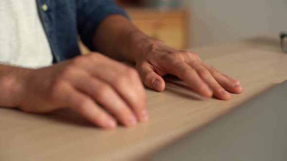 Closeup Hands of Unrecognizable Anxiously Young Man Nervously Running Fingers Over and Taps Table in
