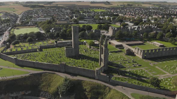 Aerial view orbiting the St Andrews Cathedral and cemetery grounds in St Andrews, Scotland, UK. ESTA