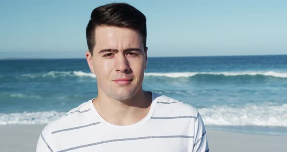 Man standing on the beach and looking at camera