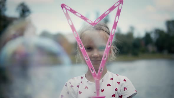 Little Girl Making Very Big Bubbles