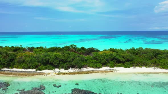 Natural fly over tourism shot of a white sandy paradise beach and turquoise sea background in best q