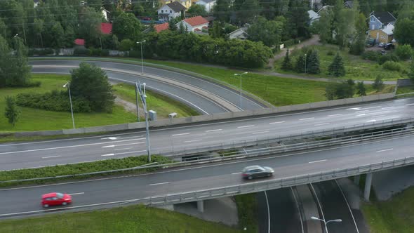 Aerial pan up of a motorway along a suburban area in Finland near Helsinki.