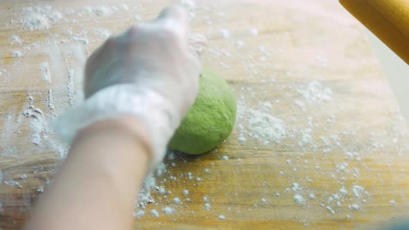 The Chef Spreads the Green Dough with a Rolling Pin
