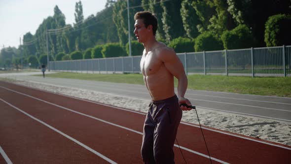 Athletic Man Jumping Rope Outdoors