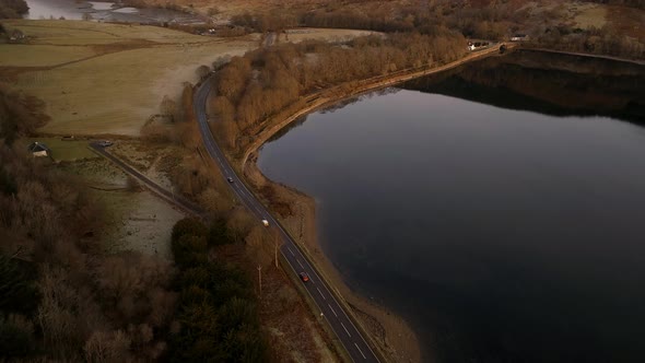 Cars on a Road Surrounding a Loch in Scotland and Landscape