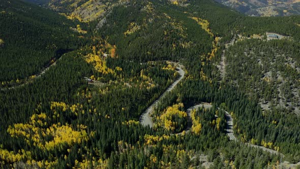 Wide Landscape aerial over beautiful yellow green fall mountain highway, 4K