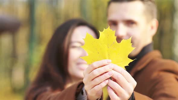 Happy Family Walking in Autumn Park on Sunny Fall Day